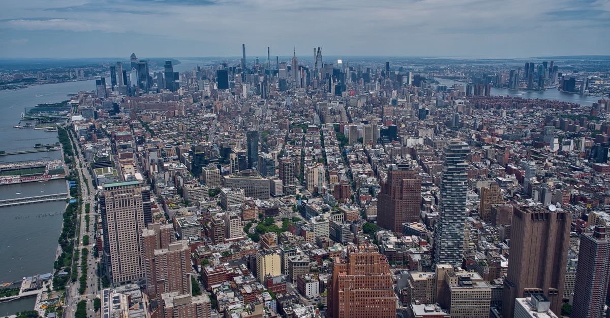 Breathtaking aerial view of the Manhattan skyline with the Hudson River, showcasing New York City's dense architecture.